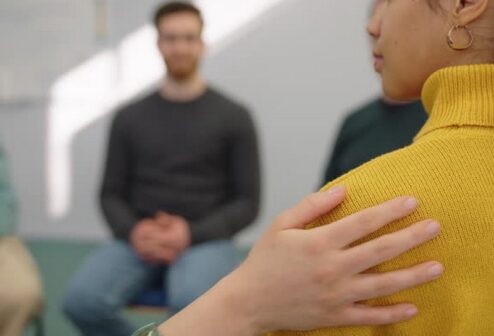 gettyimages-2152032144-640x640 Psychologist put hand on shoulder of upset young woman and supporting her. African woman getting emotional support from mental health professional during group therapy session.
