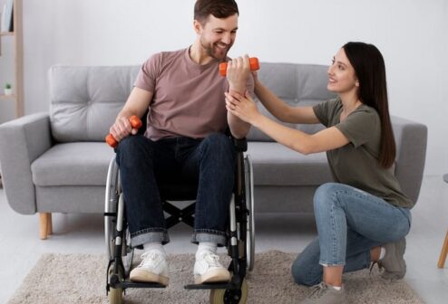 young-adult-helping-disabled-friend_23-2149433099 young-adult-helping-disabled-friend_23-2149433099